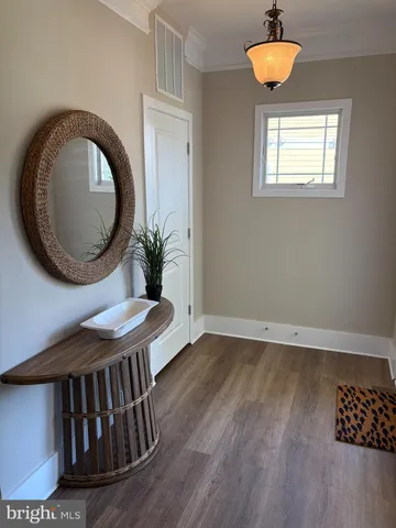 a view of entryway and hall with wooden floor
