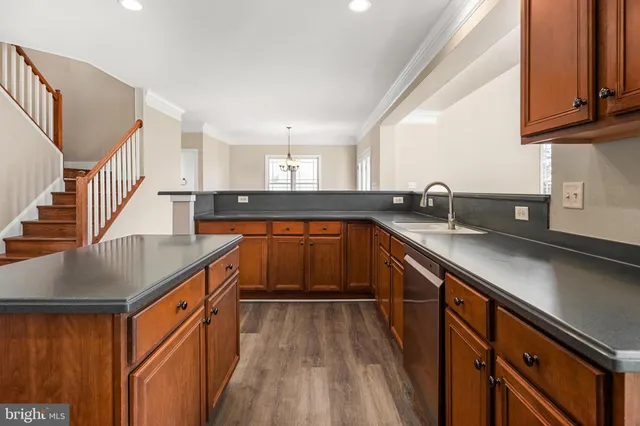 a view of a room with wooden floor and windows