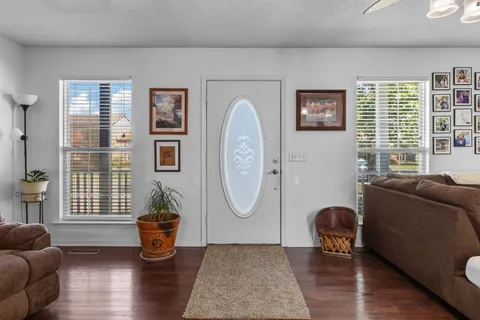 a living room with furniture a window and potted plants