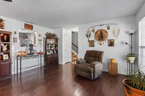 a living room with furniture and wooden floor