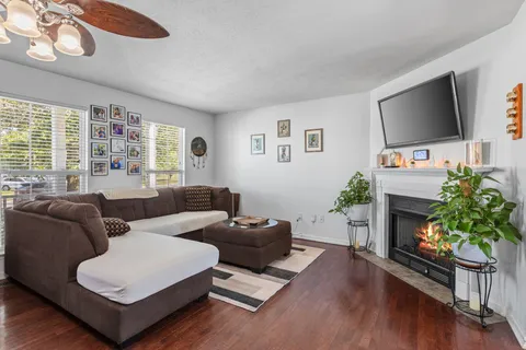 a living room with furniture a flat screen tv and a fireplace