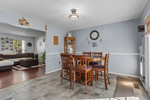 a view of a dining room with furniture and a rug