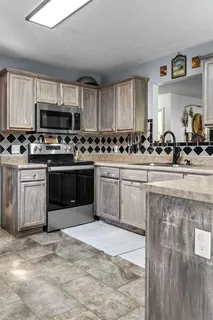 a kitchen with stainless steel appliances a sink stove and cabinets