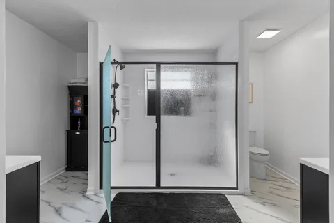 a bathroom with a glass shower door