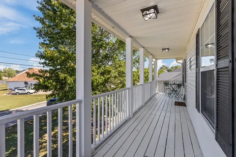 a view of a balcony with wooden floor