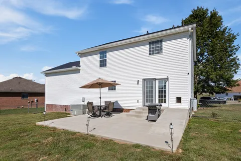 a view of a house with backyard and sitting area