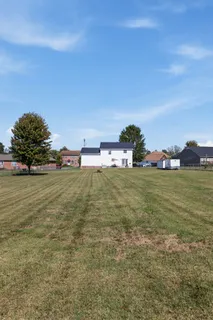 a view of a field with ocean view