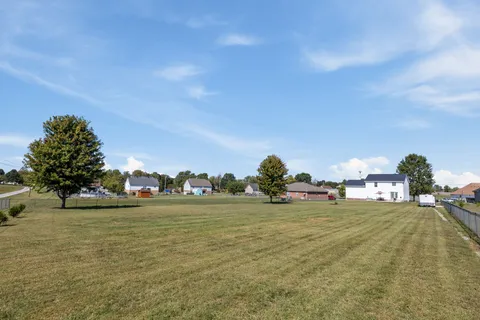 a view of a field with an ocean view