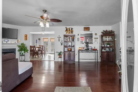 a living room with furniture and wooden floor
