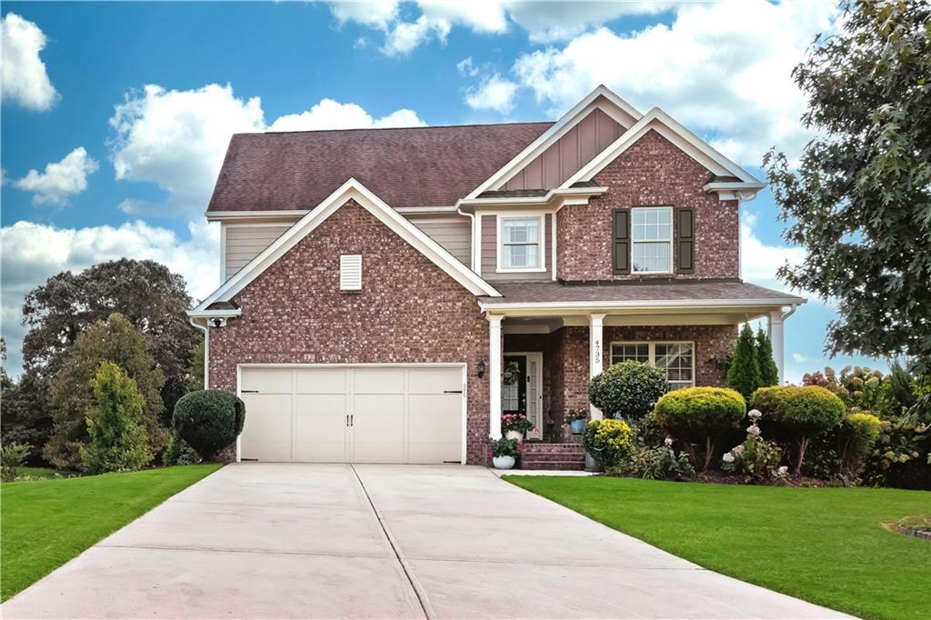 4735 Shiloh Valley Road Cumming, GA 30040 - Photo 1 of 39 a front view of a house with garden