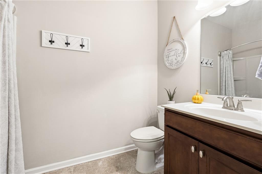 4735 Shiloh Valley Road Cumming, GA 30040 - Photo 11 of 39 a bathroom with a sink mirror vanity and toilet