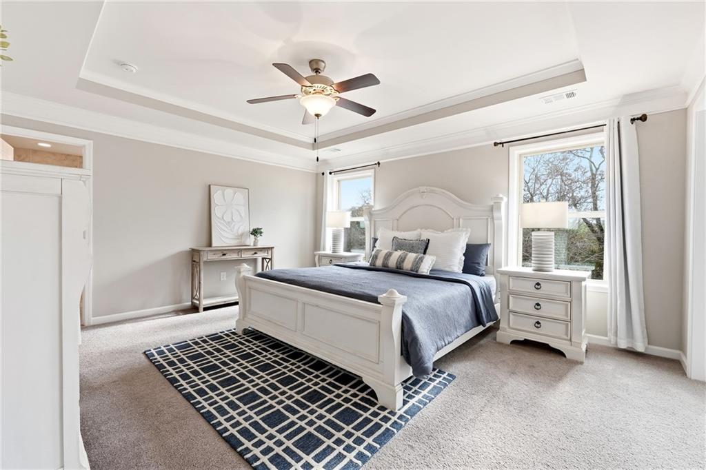 4735 Shiloh Valley Road Cumming, GA 30040 - Photo 12 of 39 a bedroom with a large bed and a chandelier