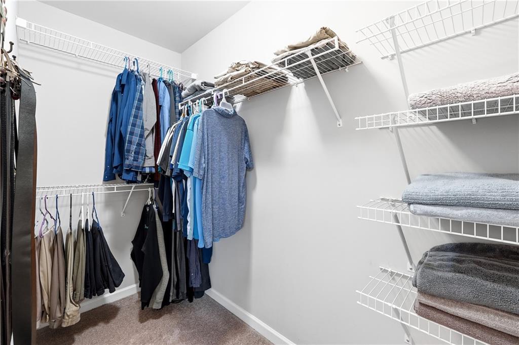 4735 Shiloh Valley Road Cumming, GA 30040 - Photo 17 of 39 a view of walk in closet with clothes and shoes