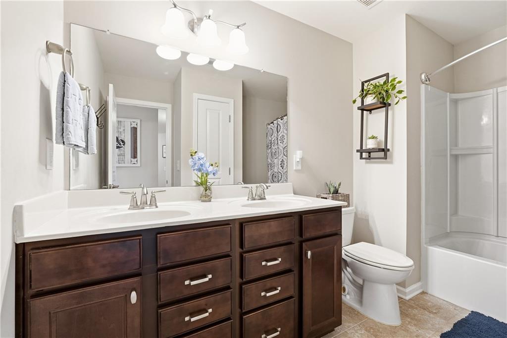 4735 Shiloh Valley Road Cumming, GA 30040 - Photo 21 of 39 a bathroom with a sink vanity toilet and shower