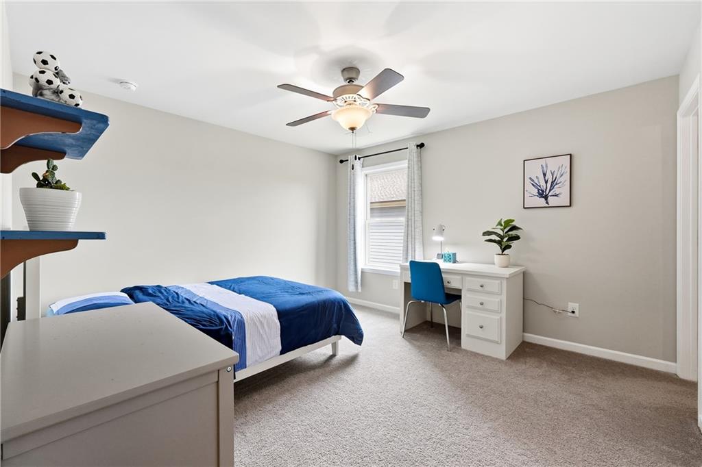 4735 Shiloh Valley Road Cumming, GA 30040 - Photo 23 of 39 a bedroom with a bed and a chandelier