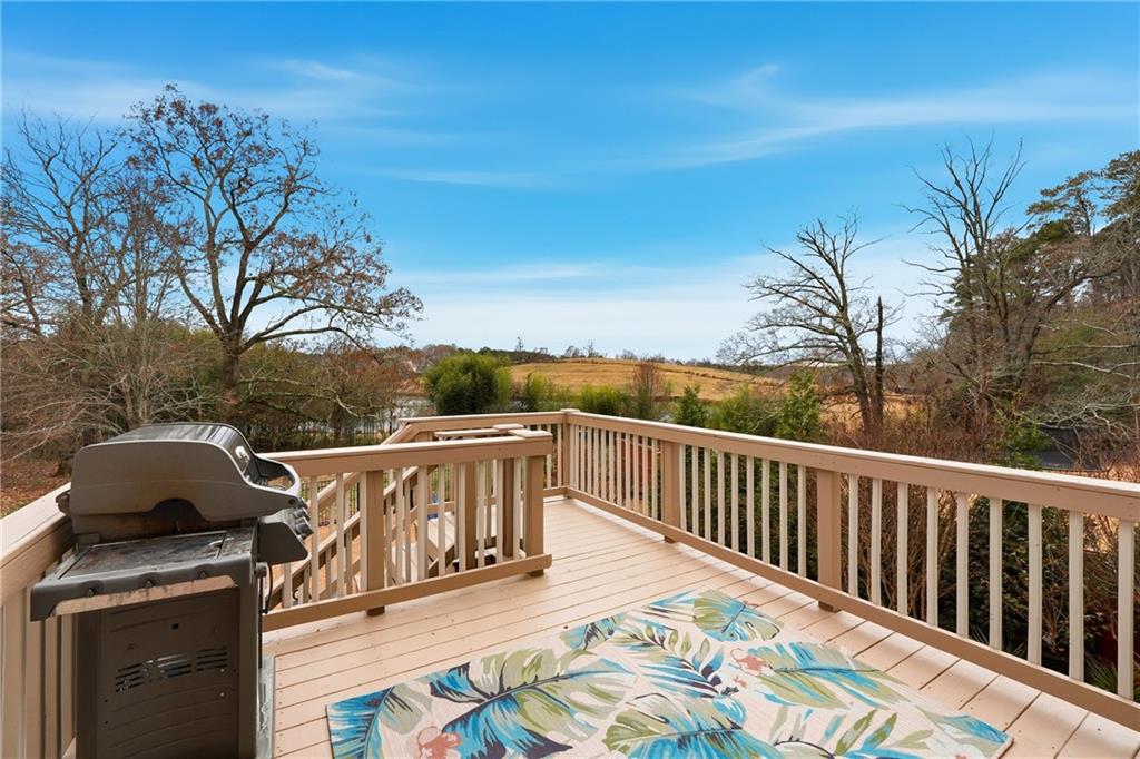 4735 Shiloh Valley Road Cumming, GA 30040 - Photo 27 of 39 a view of a roof deck with couches and wooden floor