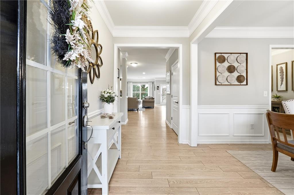 4735 Shiloh Valley Road Cumming, GA 30040 - Photo 3 of 39 a view of a hallway with wooden floor and furniture