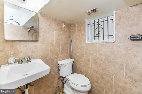 a white toilet sitting next to a bathroom sink