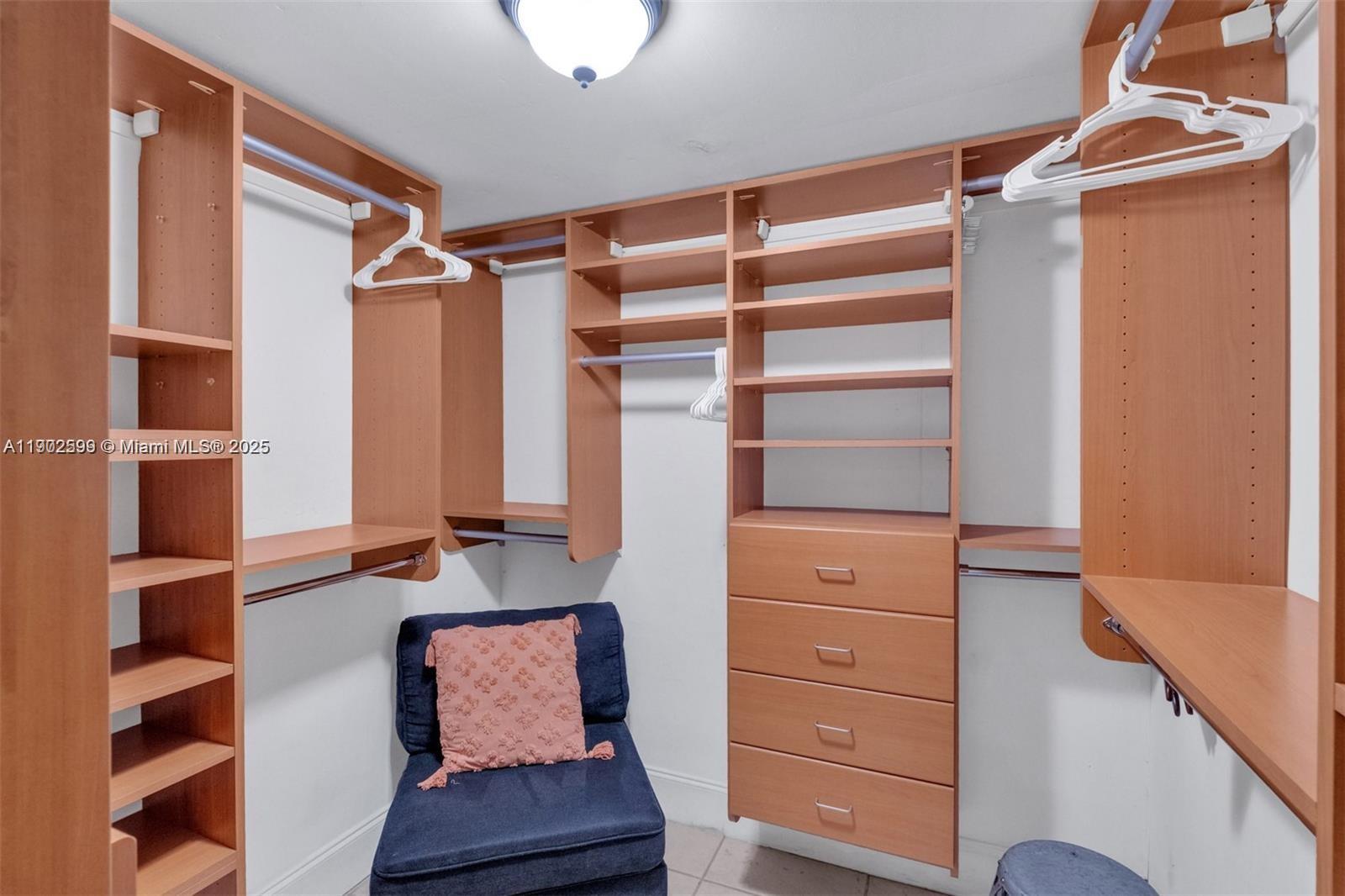 1033 Northwest 6 Street, Unit A Miami, FL 33136 - Photo 12 of 35 walk in closet with clothes and shoes