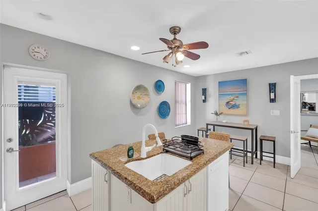 a view of a kitchen and a dining table with chairs