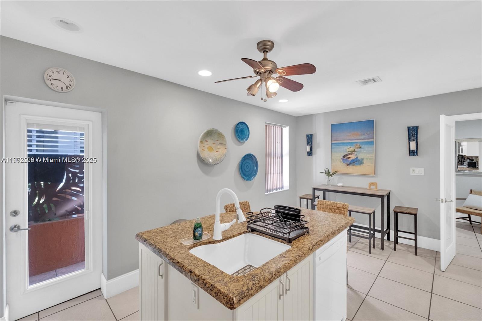 1033 Northwest 6 Street, Unit A Miami, FL 33136 - Photo 15 of 35 a view of a kitchen and a dining table with chairs