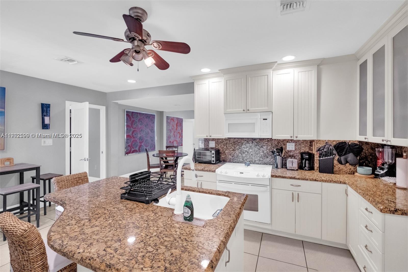 1033 Northwest 6 Street, Unit A Miami, FL 33136 - Photo 16 of 35 a large kitchen with a large counter top space appliances and cabinets