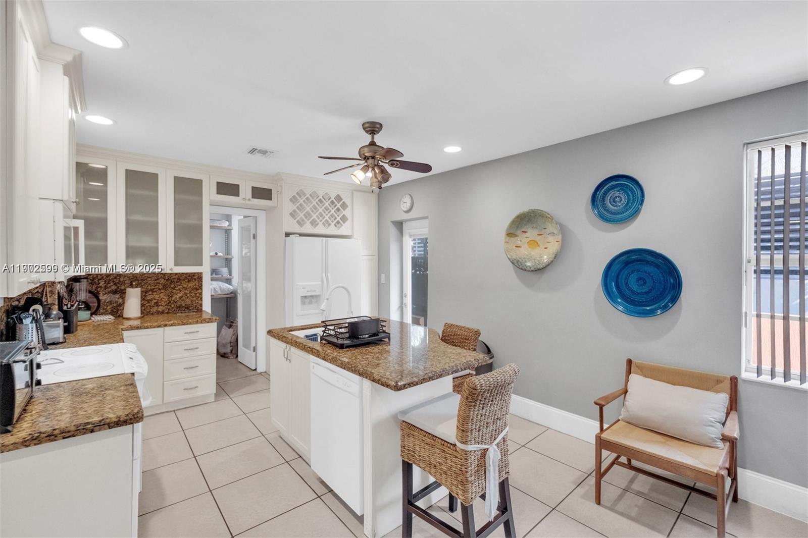 1033 Northwest 6 Street, Unit A Miami, FL 33136 - Photo 18 of 35 a kitchen with a table and a clock on the wall