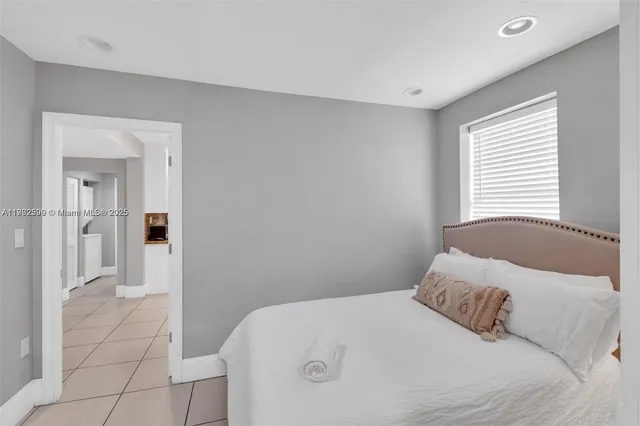 a bedroom with a bed and a mirror