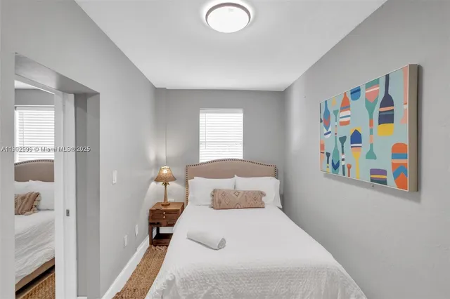 a bedroom with a bed and a painting on the wall