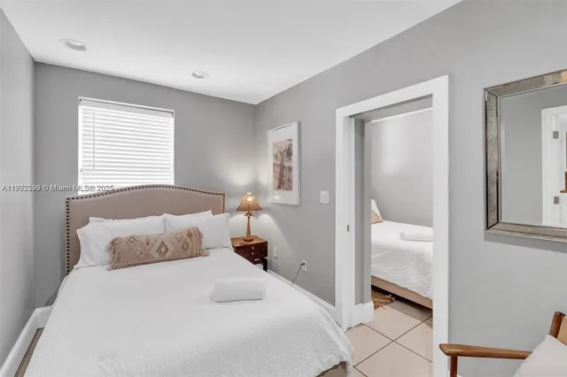 a bedroom with a bed and a mirror