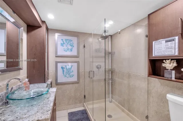 a spacious bathroom with a granite countertop tub sink and shower