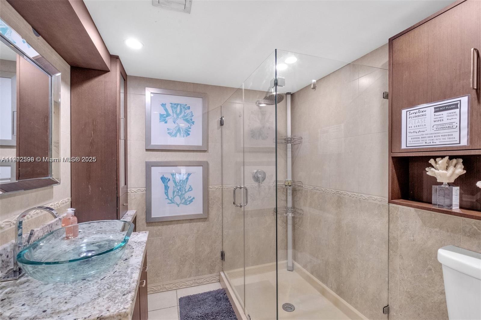 1033 Northwest 6 Street, Unit A Miami, FL 33136 - Photo 26 of 35 a spacious bathroom with a granite countertop tub sink and shower