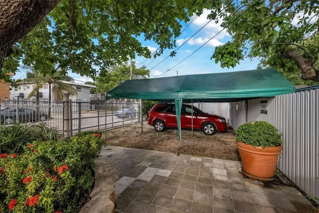 a view of a patio with table and chairs under an umbrella