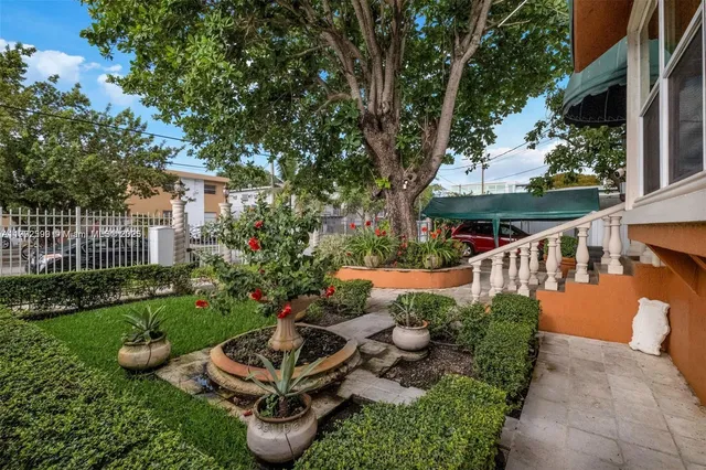 a balcony with plants and outdoor seating