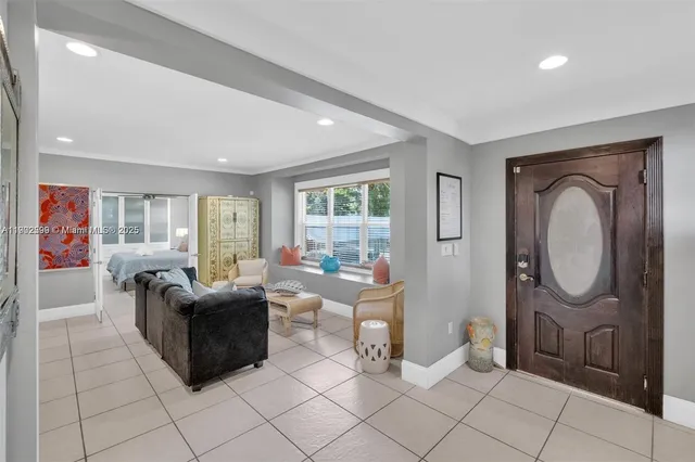 a living room with furniture a window and a mirror