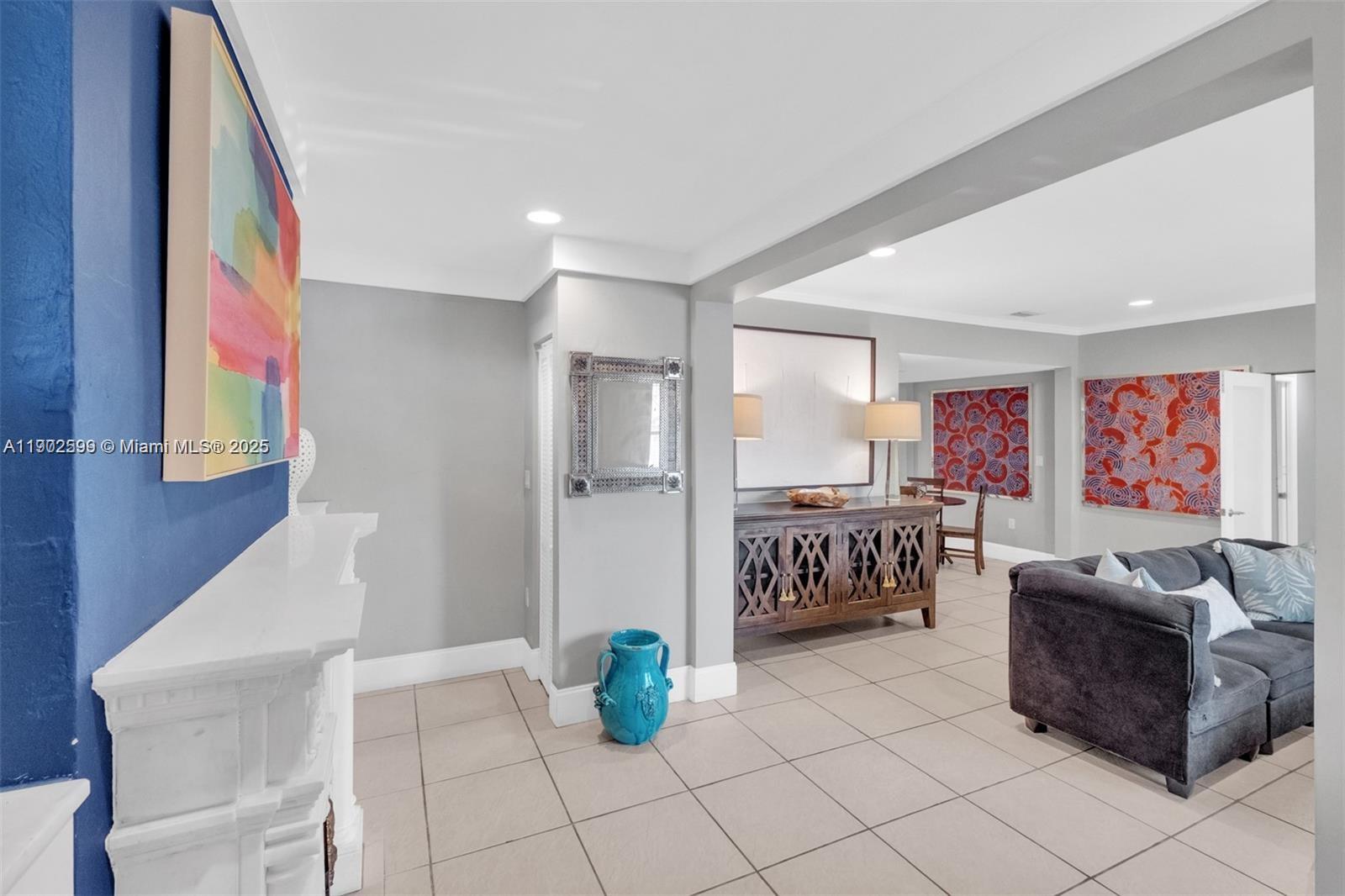 1033 Northwest 6 Street, Unit A Miami, FL 33136 - Photo 7 of 35 a living room with fireplace furniture and a table