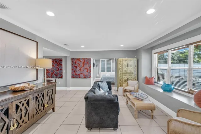 a living room with furniture and large windows