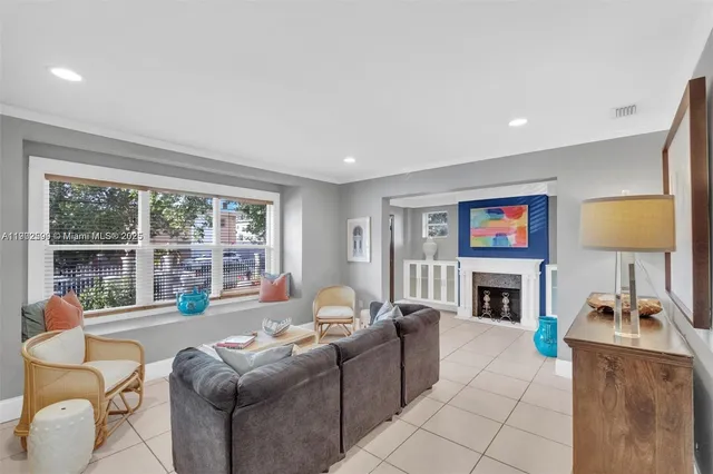 a living room with furniture large window and a fireplace