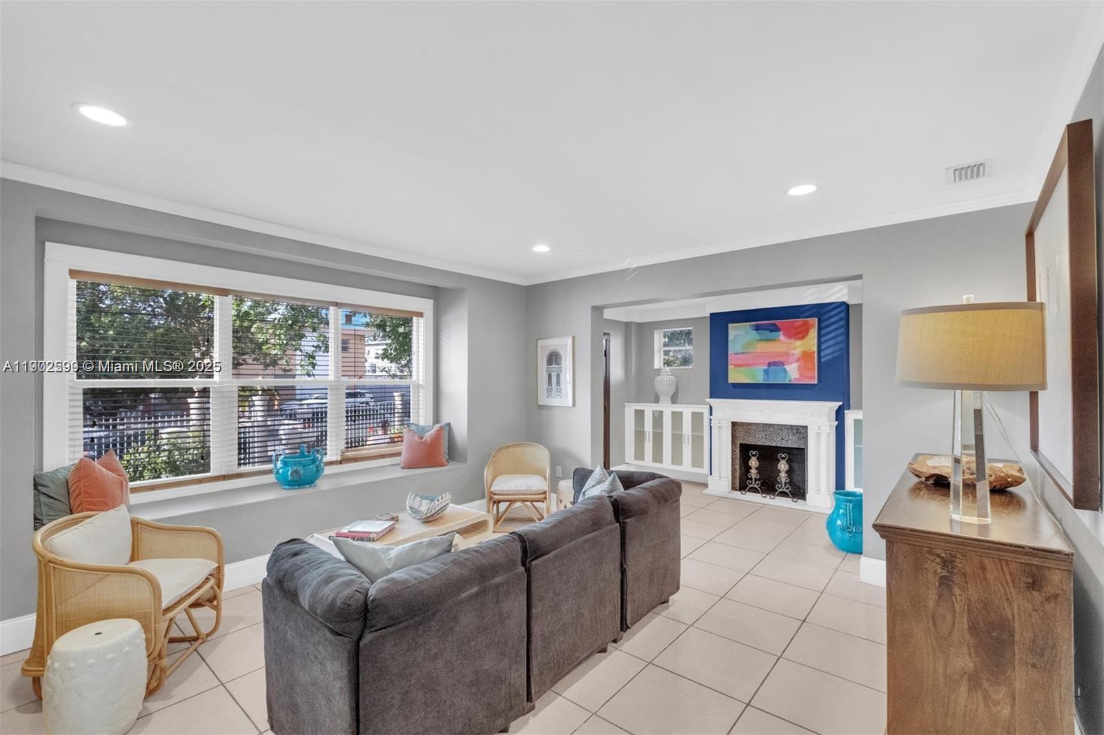 1033 Northwest 6 Street, Unit A Miami, FL 33136 - Photo 9 of 35 a living room with furniture large window and a fireplace