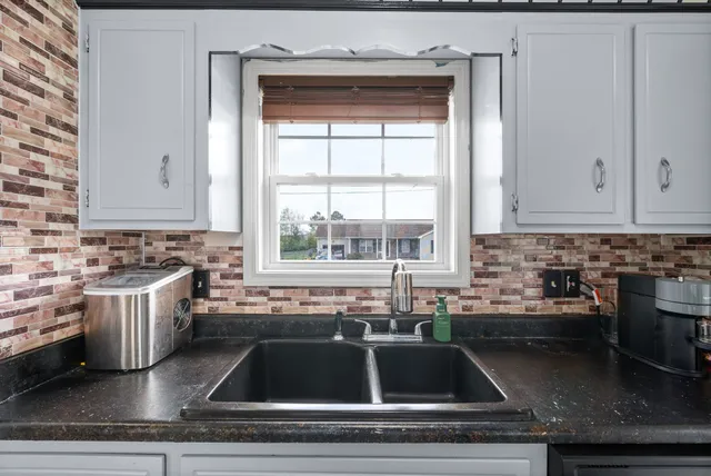 a kitchen with a sink and cabinets