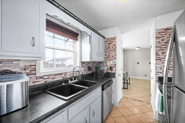 a kitchen that has a sink and a stove