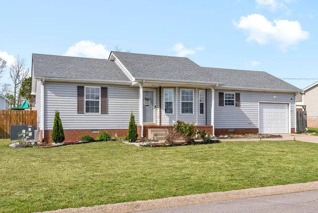a front view of house with yard and green space
