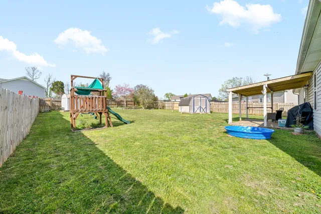 a view of a house with backyard and a garden