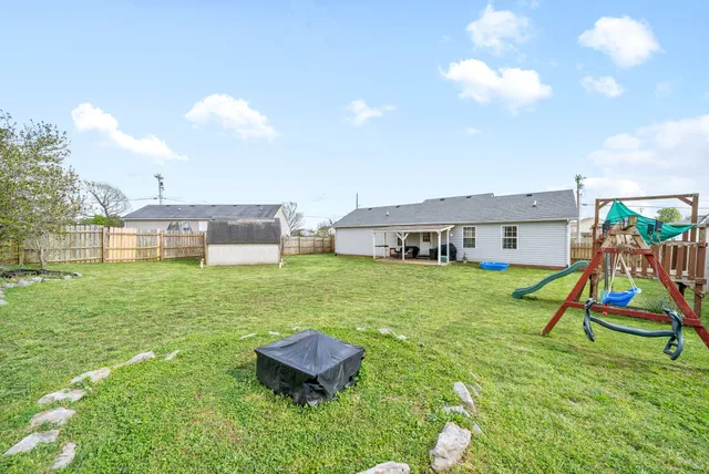 a view of a house with a backyard porch and sitting area