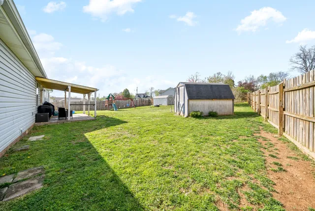 a view of a house with backyard and porch