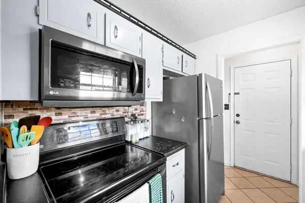a stove top oven sitting inside of a kitchen