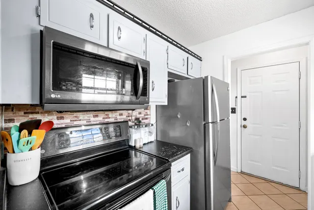 a stove top oven sitting inside of a kitchen