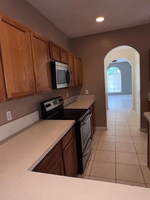 13922 Southwest 278th Street Homestead, FL 33032 - Photo 78 of 133 a kitchen with stainless steel appliances a sink a stove a microwave a counter top and cabinets