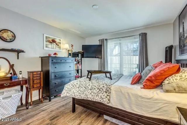 a bedroom with a bed and a dresser in it