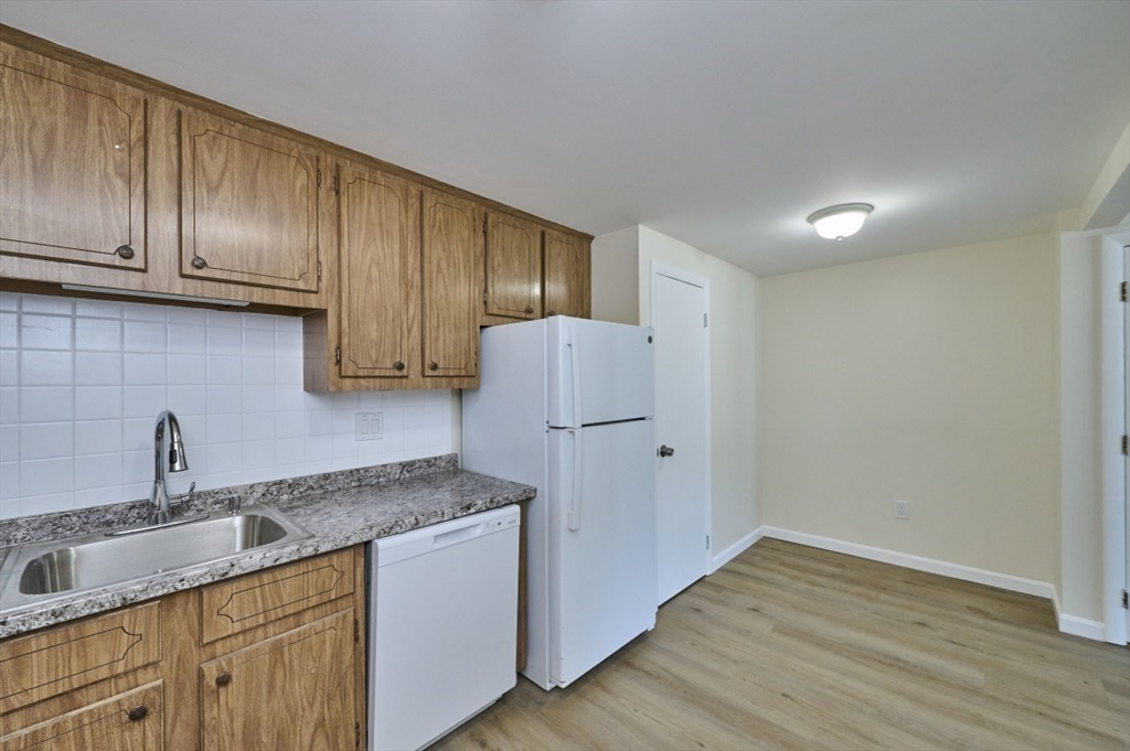 15 Old Colony Lane, Unit 7 Arlington, MA 02476 - Photo 2 of 12 a kitchen with a sink cabinets and wooden floor